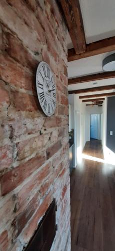 a clock on the side of a brick wall at FeWo Rohleder de 130m mit Garten 6Pers 2Bad in Cottbus