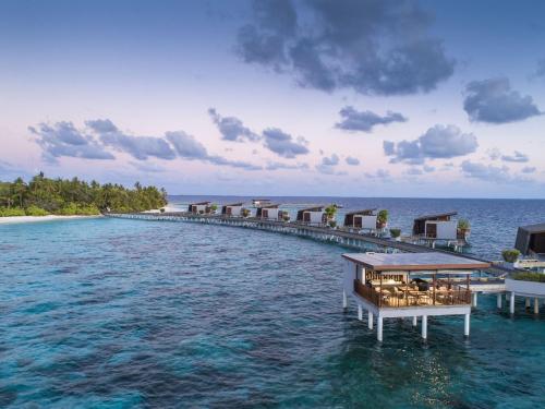 an island in the ocean with a restaurant on a pier at Park Hyatt Maldives Hadahaa in Gaafu Alifu Atoll