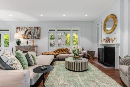 a living room with a couch and a table at Villa Northcote Luxurious 4BR Wood Fireplace Leura in Leura
