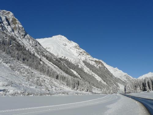a road in the mountains with snow on it at Haus Bergheim in Sankt Leonhard im Pitztal