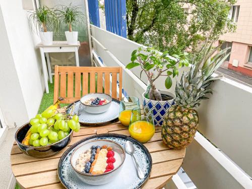 a table with plates of food on a balcony at Votre Escale Boule d Or Sauna & Spa in Niort