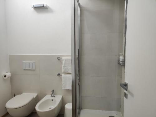 a bathroom with a shower and a toilet and a sink at Santa Marta Rooms in Vernazza