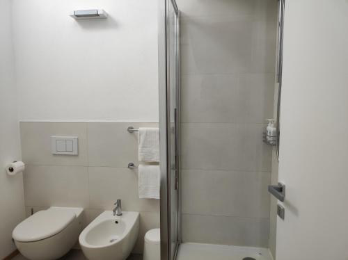 a bathroom with a shower and a toilet and a sink at Santa Marta Rooms - Via Roma 23 in Vernazza