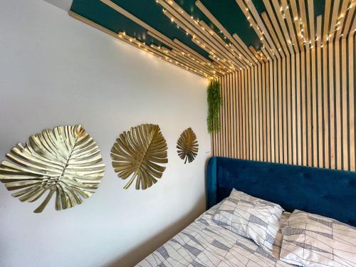 a bedroom with two large leaves on the wall at Votre Escale Boule d Or Sauna & Spa in Niort