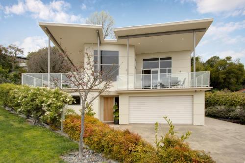 a large white house with a balcony at Havelock Wine Down - Havelock North Holiday Home in Havelock North