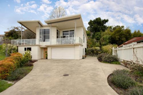a large white house with a driveway at Havelock Wine Down - Havelock North Holiday Home in Havelock North