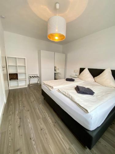 a bedroom with a large bed and a chandelier at Willinger Perle 69 in Willingen
