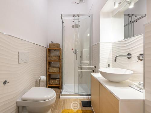 a bathroom with a toilet and a sink and a shower at Casa Aura in Oristano