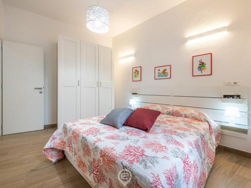 a bedroom with a bed with two pillows on it at Casa Aura in Oristano