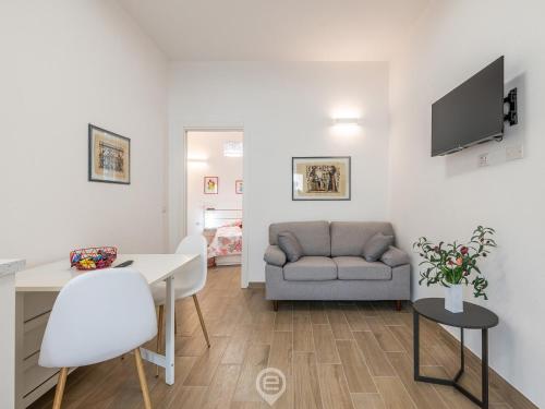a living room with a couch and a table at Casa Aura - City Centre in Oristano