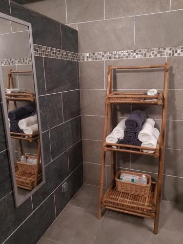 a bathroom with towels and baskets in a shower at bambôô in Les Avirons