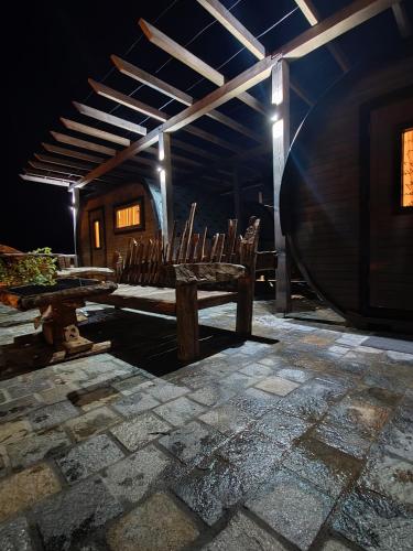 a room with chairs and a table and a barrel at Namaste къща в село Камилски дол in Kamilski Dol