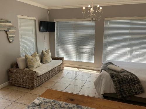 a living room with a couch and a chandelier at UpperRoom Ceres -Indoor Braai in Ceres