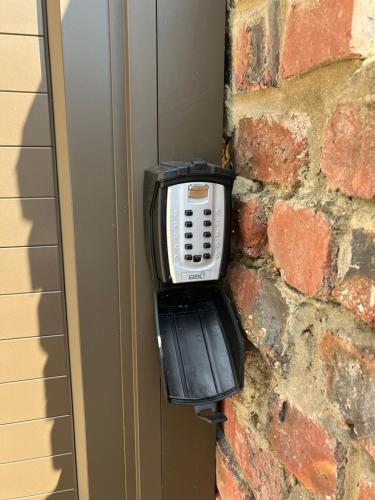 a phone is attached to a brick wall at UpperRoom Ceres -Indoor Braai in Ceres