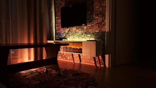a fireplace in a living room with a tv above it at Edirne House in Edirne