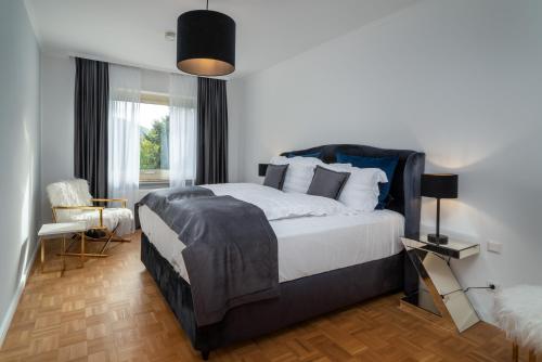 a bedroom with a large bed and a window at Blue Sky Apart Center Baden-Baden in Baden-Baden