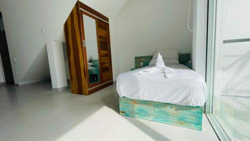 a bedroom with a bed and a large mirror at Villa LA Kurumba in Ambalangoda