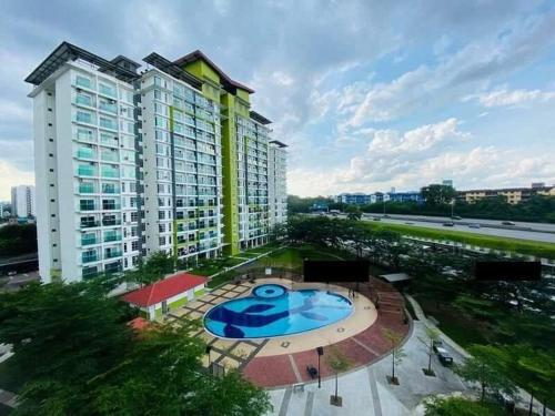 a large building with a pool in front of it at INFA - Muslim House @ Seroja Apartment, Johor Bahru in Johor Bahru