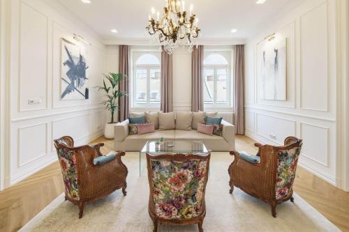 a living room with a couch and two chairs at Broadway Residence in Budapest