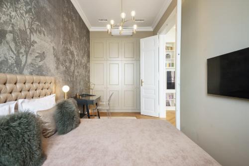 a bedroom with a large bed and a tv at Broadway Residence in Budapest