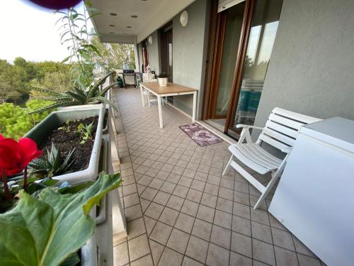 a balcony with a table and a bench on a house at Sisters'House in Lido