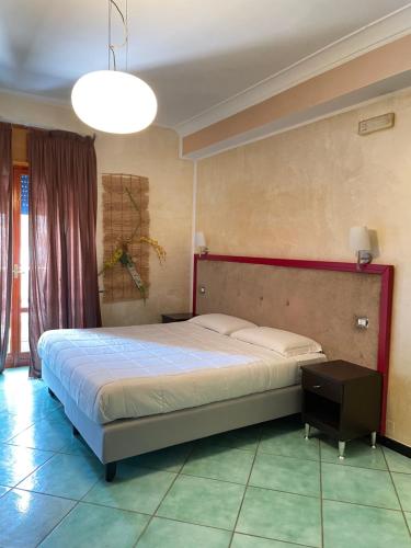 a bedroom with a large bed in a room at Costa Sud Salerno in Salerno