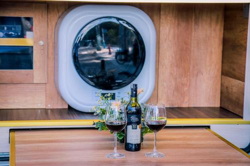 two glasses of wine sitting on a table in a boat at Le Phan Hotel in Tây Ninh