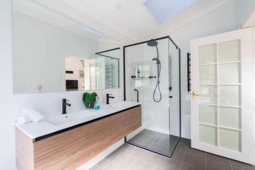 a white bathroom with a sink and a shower at Bryn-y-Mor Cottage Romantic Fireplace Couples in Leura