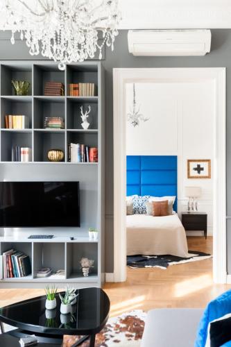 a living room with a blue accent wall at Broadway Residence in Budapest