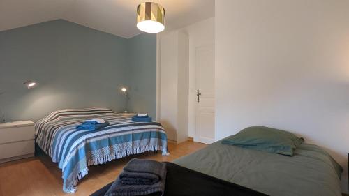 a bedroom with two beds in a room at Le Moulin de la Motte - 12 personnes in Bellenot-sous-Pouilly
