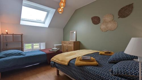 a bedroom with two beds and a window at Le Moulin de la Motte - 12 personnes in Bellenot-sous-Pouilly