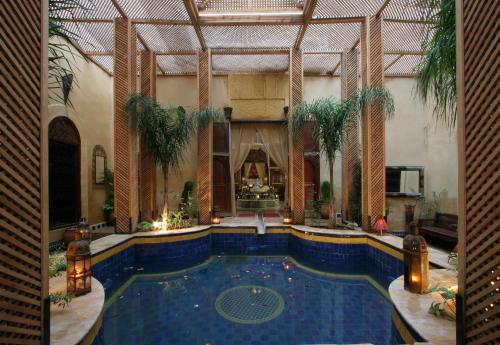 a large swimming pool in a large building at Palais AL Firdaous in Fès