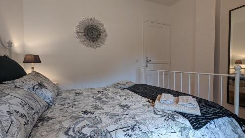 a bedroom with a bed with two towels on it at Le Moulin de la Motte - 12 personnes in Bellenot-sous-Pouilly
