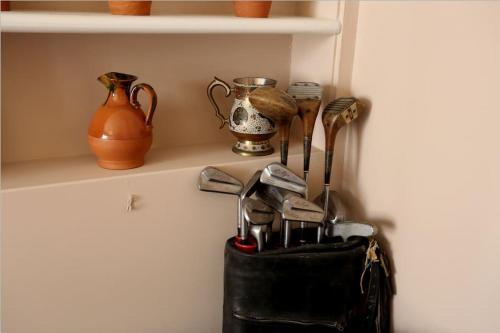 a shelf with various vases and a purse on it at Charming Victorian Townhouse in Oxford Center in Oxford