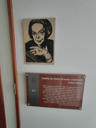 a sign on a wall with a picture of a woman at Monte Do Malhao - Art, Eco & Spa in Castro Marim