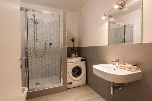 La salle de bains est pourvue d'un lavabo et d'un lave-linge. dans l'établissement Apartments Florence-4 bedroom in Pellicceria (sx), à Florence