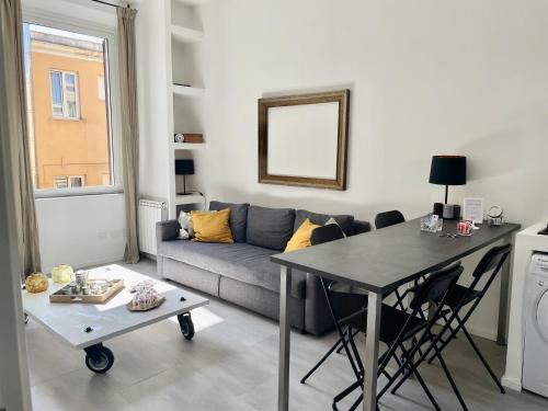 a living room with a couch and a table at Loft Esquilino Terrazza a Stazione Termini in Rome