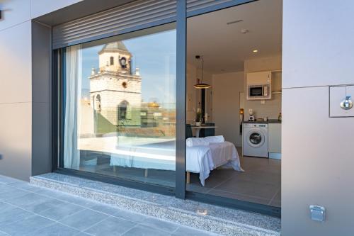 a kitchen with a view of a building through a window at Edificio Santiago by Plaza Mayor Apartamentos in Valladolid