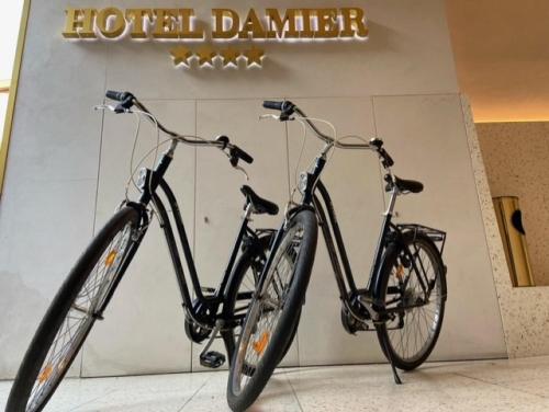 two bikes parked in front of a hotel garage at Hotel Damier Kortrijk in Kortrijk