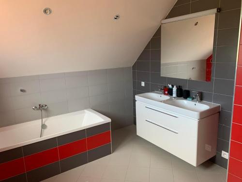 a bathroom with a sink and a bath tub and a sink at Bikehouse in Veľká Lomnica