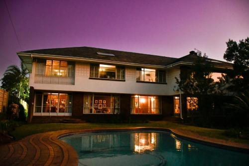 a house with a swimming pool in front of it at THE WHITE HOUSE in Johannesburg