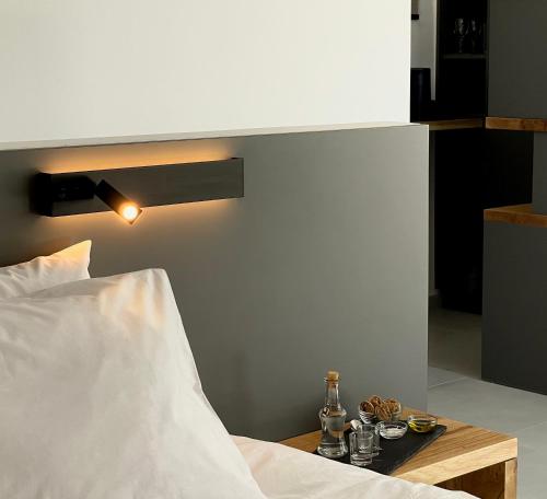 a bedroom with a bed and a table with drinks on it at O Mikros Kosmos Hotel Resort - Adults Only in Sívas