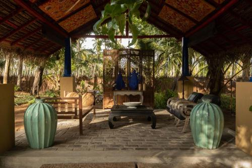 a pavilion with blue vases on a patio at Luna Laguna in Kalpitiya