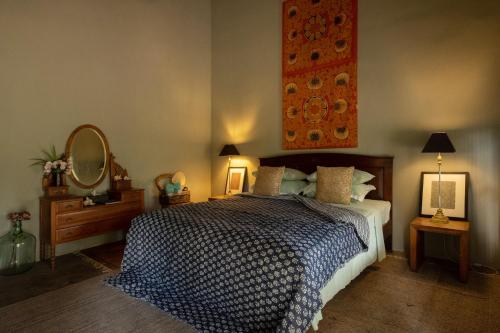 a bedroom with a large bed and a mirror at Luna Laguna in Kalpitiya