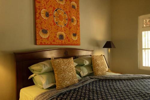 a bedroom with a bed with a picture on the wall at Luna Laguna in Kalpitiya