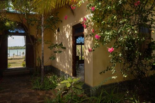 a building with flowers on the side of it at Luna Laguna in Kalpitiya