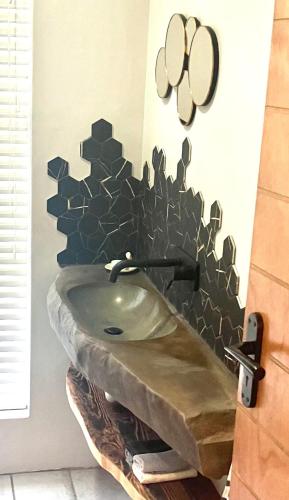 a bathroom with a sink with a mirror on the wall at UpperRoom Ceres -Indoor Braai in Ceres