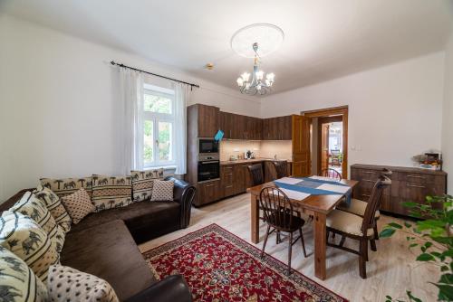 a living room with a couch and a table at Historic Villa Apartments in Prague