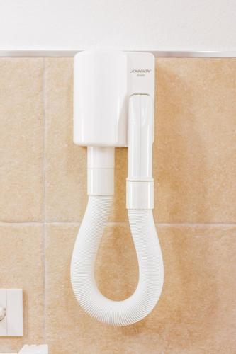 a white light on a wall in a bathroom at La Vinia Bed&Wine Experience - Adults Only in Sassari