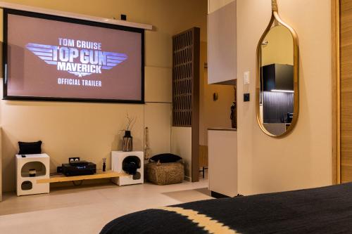 a bedroom with a projection screen and a bed at Host Inn Le Lumiere SPA & CINÉMA in Lyon